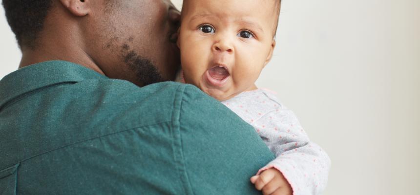 Dad holding yawning baby
