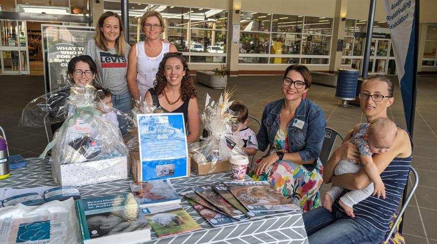 Mothers gathered at a local shopping complex with babies and young children celebrating National Mothering Week.