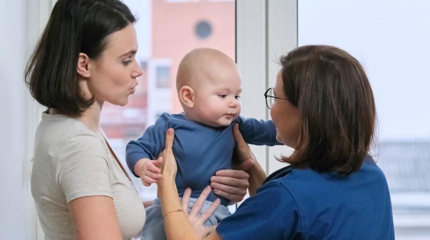 Health professional with mother and baby