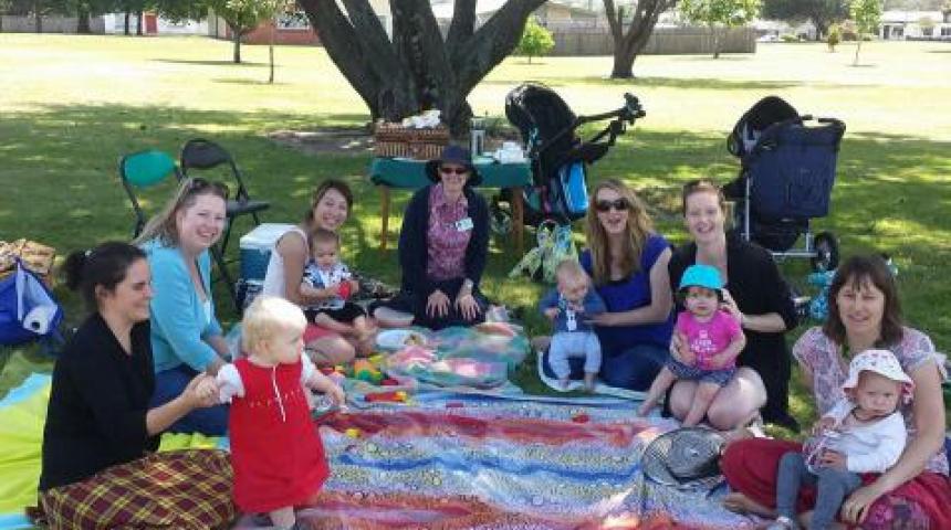 Mothers, children, prams, picnic rug outdoors