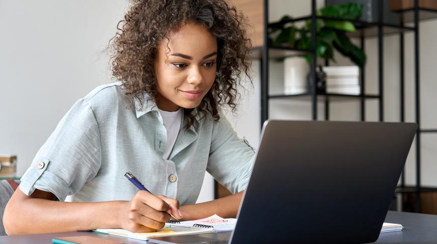 A woman works at her laptop