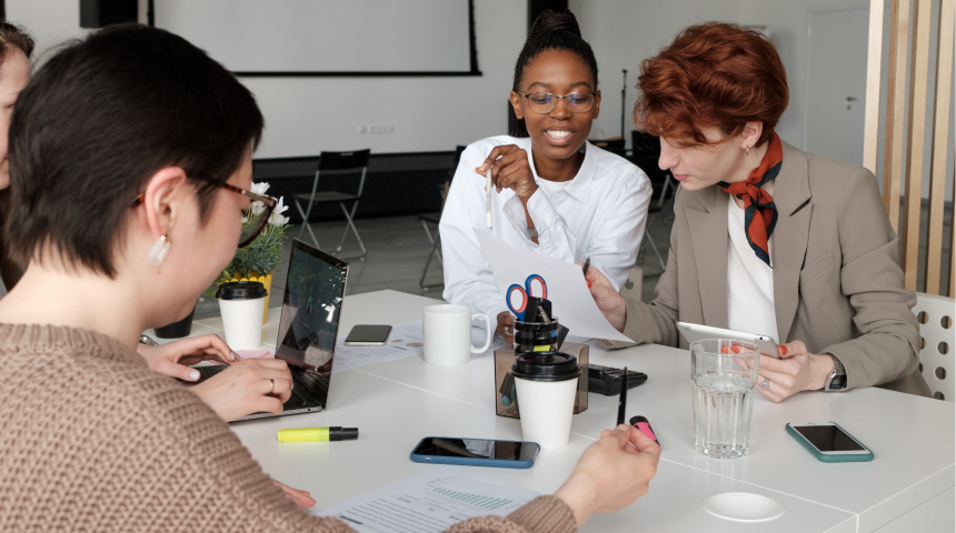 Three women sitting around table working