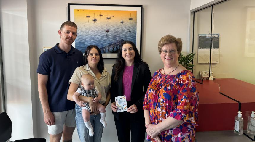 4 adults and 1 infant standing looking at the camera presenting a breastfeeding is welcome everywhere sticker