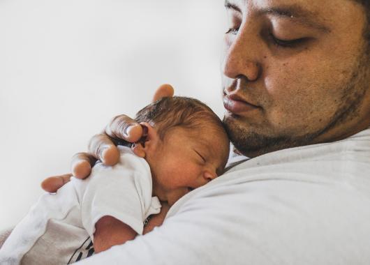 Father holding newborn baby