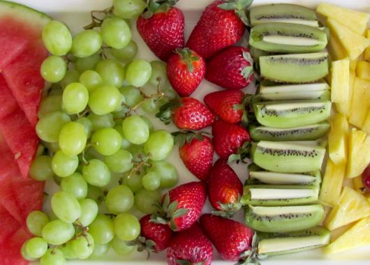 Cut fruit on a tray: watermelon, grapes, strawberries, kiwi fruit, pineapple