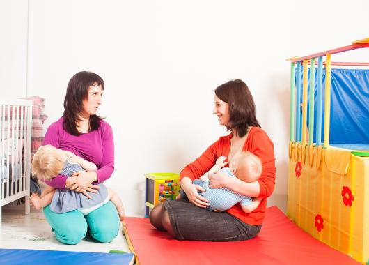Two mums breastfeeding toddlers at play centre