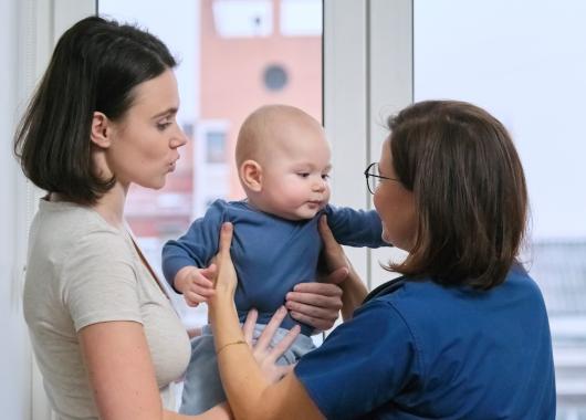 Health professional with mother and baby