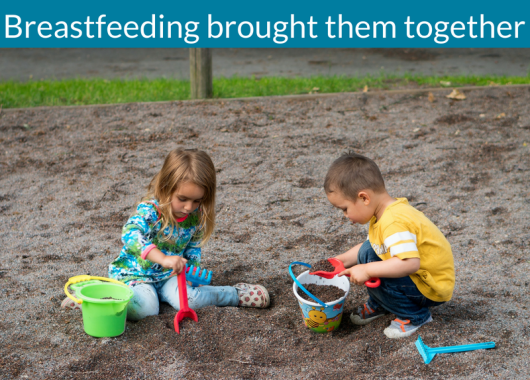 Two children are playing in the sand with buckets and spades