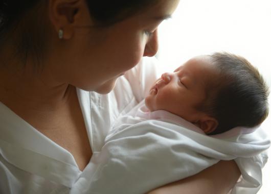 mum looking up close at baby