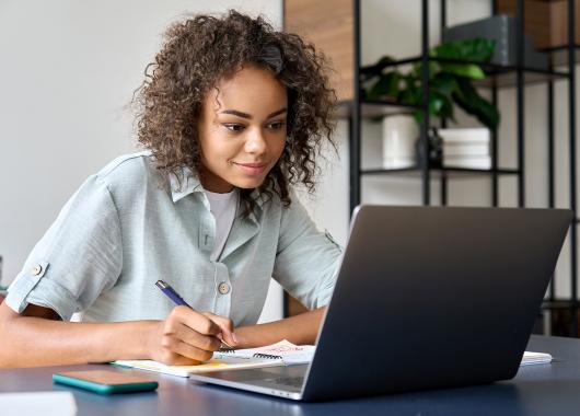 A woman works at her laptop