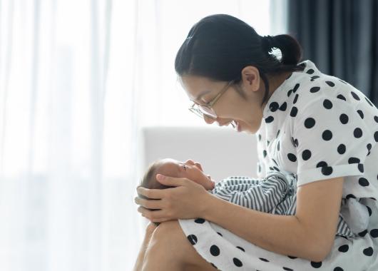 A mother and baby smile at each other