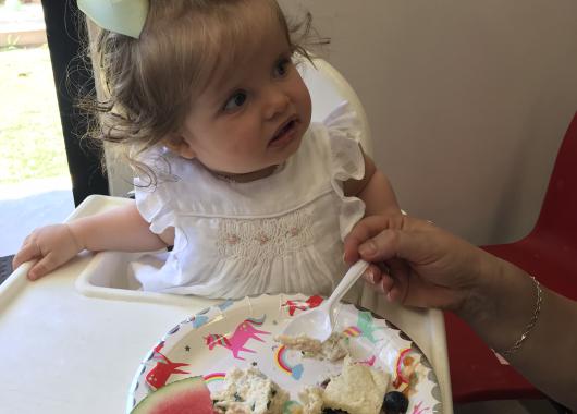 Baby with plate of food