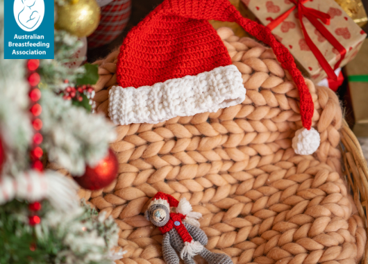 Christmas themed baby hat near some festive decorations