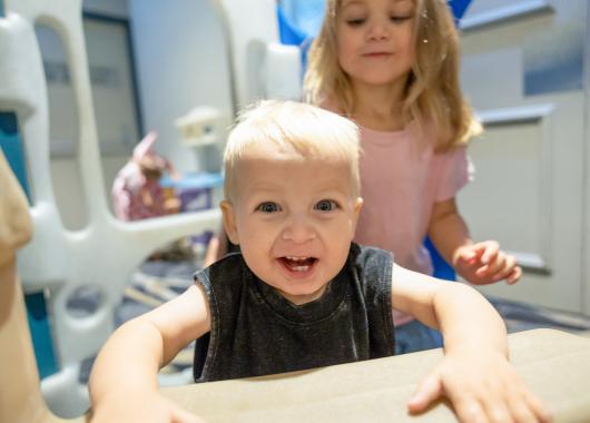 Two children smiling at the camera.