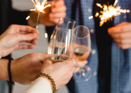People holding sparklers, toasting with champagne