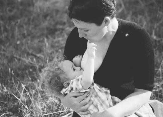 woman breastfeeding a toddler