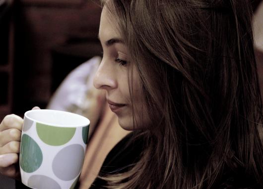 woman drinking a hot drink
