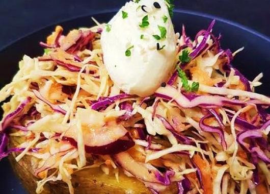 Baked potato with coleslaw and sour cream