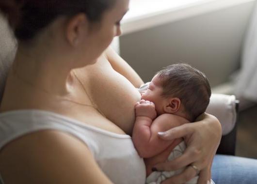 Photo of a mum breastfeeding a very young baby