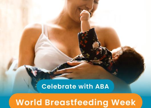Mother wearing a white top and breastfeeding her child. 