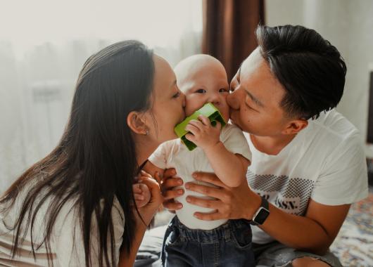 Two parents holding their baby