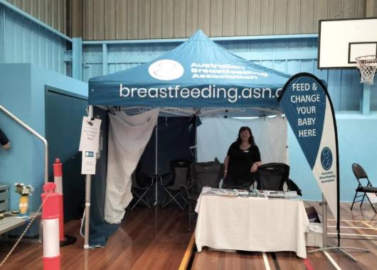 Volunteer standing in ABA tent