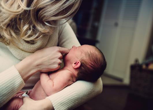 A mother holds her crying baby