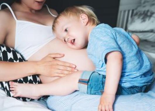 bigstock-Pregnant-Mother-And-Son-At-Hom-183853837