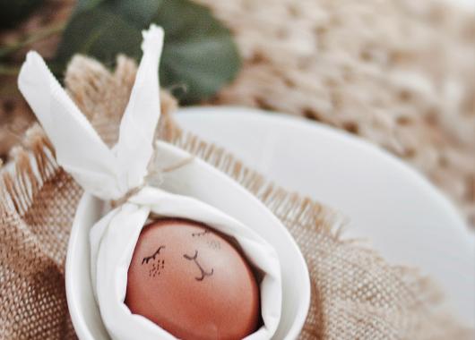 An egg with a bunny face drawn 