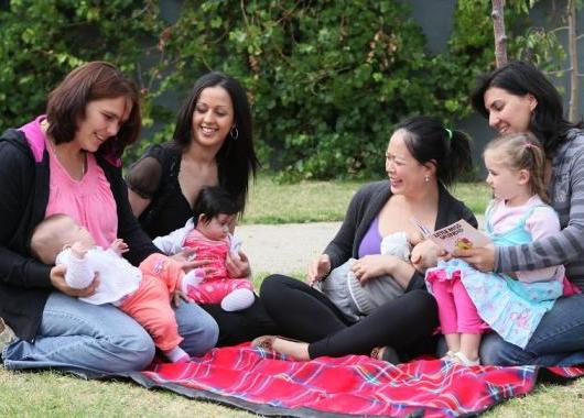 women and children on picnic rug