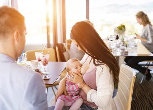 Mum breastfeeding at restaurant 