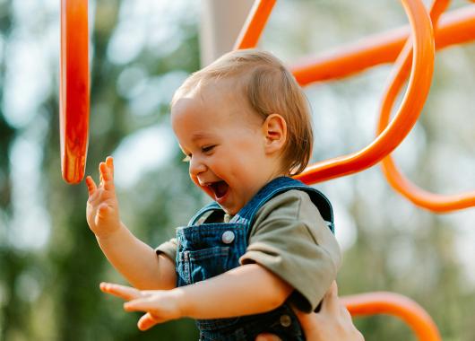 A young child playing at the playground