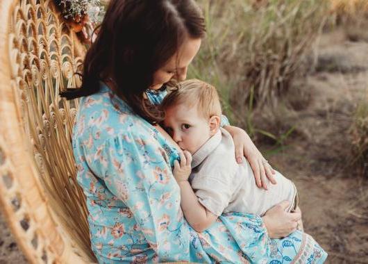 mum holding an older baby in a snuggle