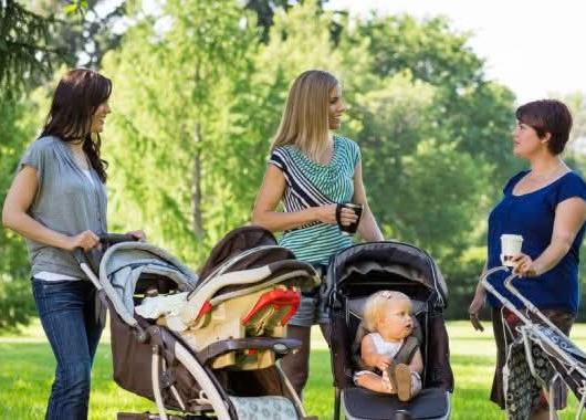 Three ladies meeting with babies in prams. The mums are talking with each other