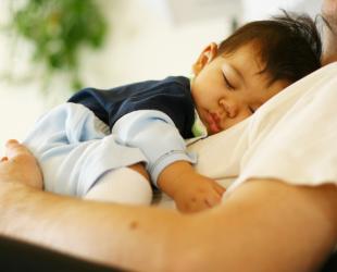 father holding sleeping baby