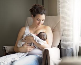 mother breastfeeding in chair