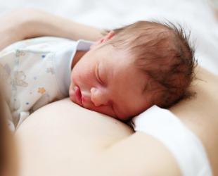 Baby sleeping on mother's chest
