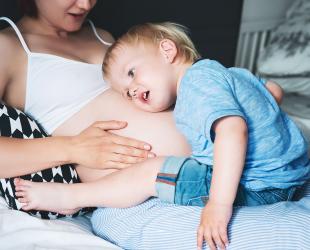 boy listens to mother's tummy