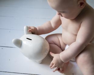 baby with piggy bank