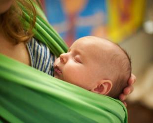 Mum holding baby in sling