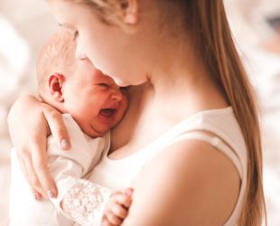 Mother holding crying baby