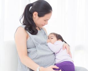 Pregnant mum breastfeeding