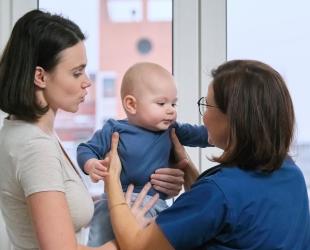 Health professional with mother and baby