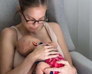 A mother holds her newborn baby