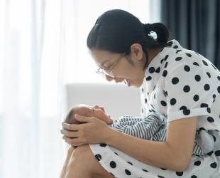 A mother and baby smile at each other