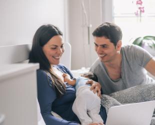 new parents viewing laptop