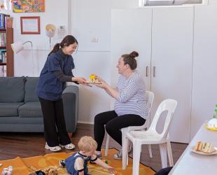 Volunteer supporting mother and baby in evacuation centre