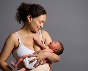 A mother holds her newborn baby
