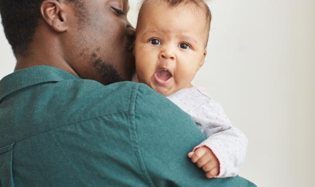 Dad holding yawning baby