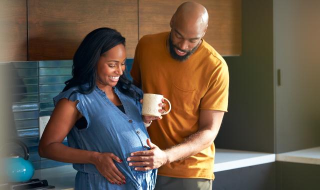 Pregnant  couple in kitchen